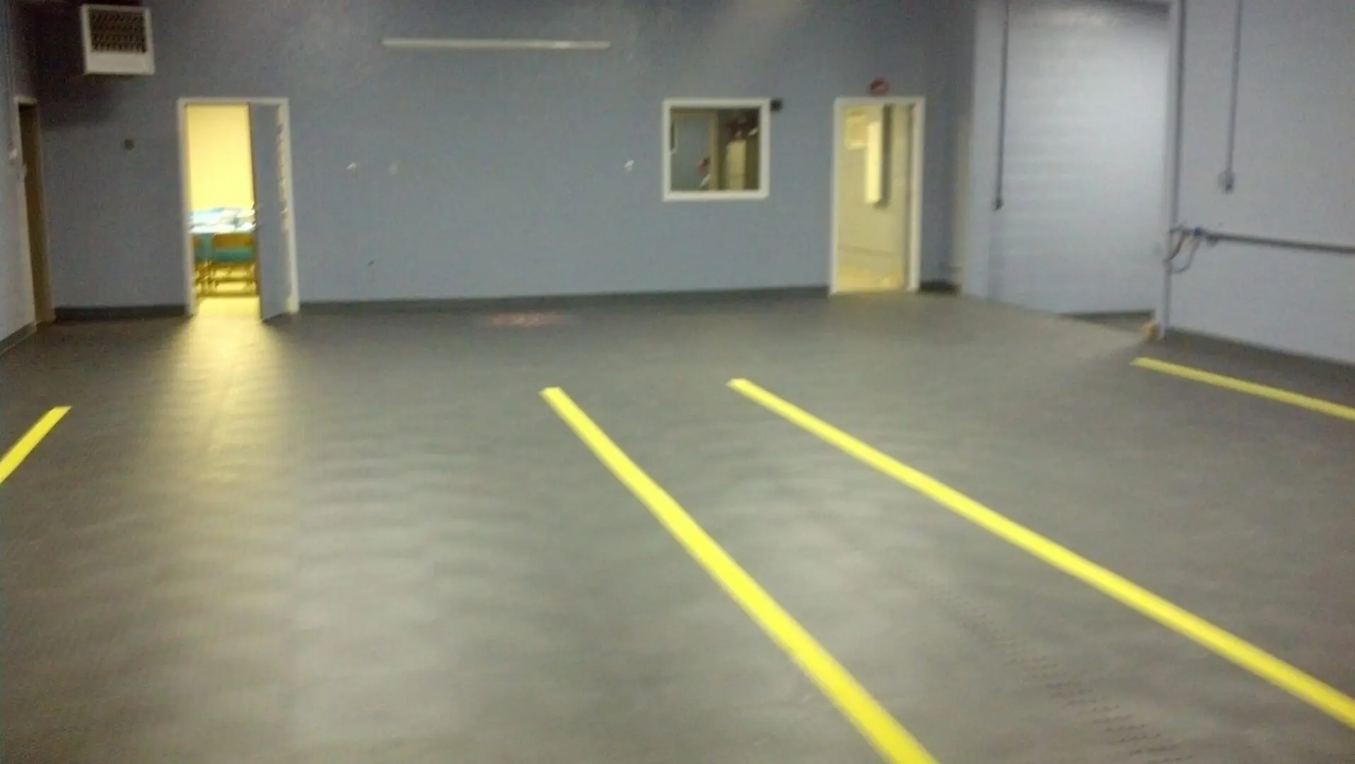 A room with two yellow lines painted on the floor.