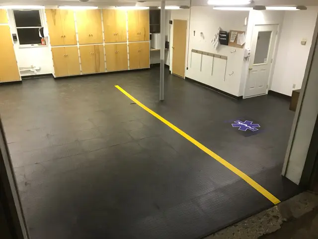 A room with yellow lines on the floor and cabinets