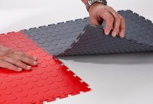 A person is putting together a red and gray floor.