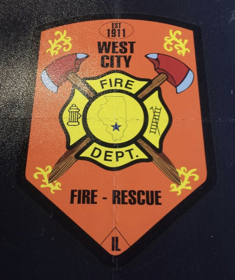 A fire department patch with two axes and the words west city fire dept.