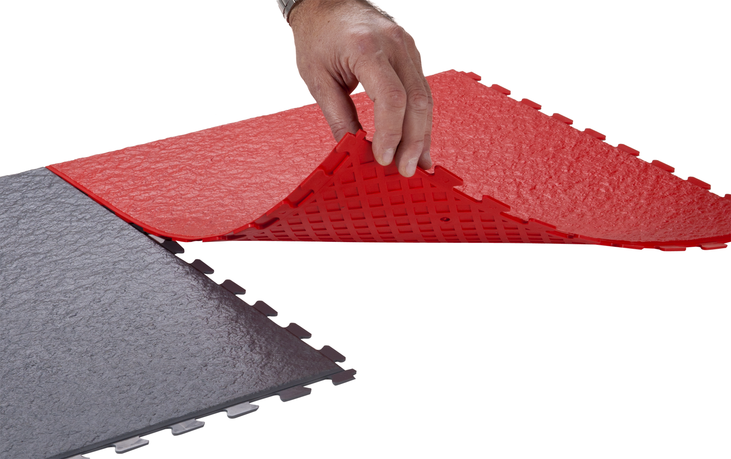 A hand is touching the bottom of a red mat.