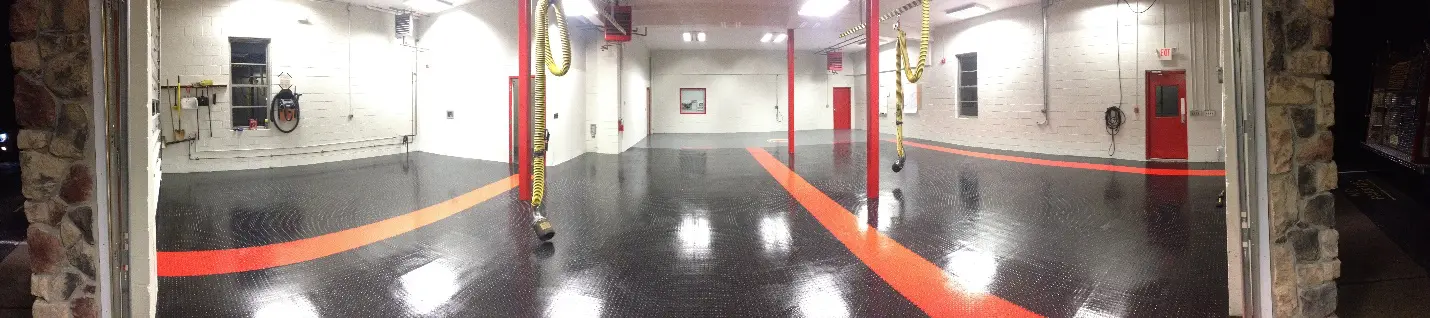 A garage with black and red floor in it